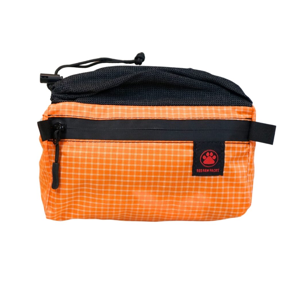 Flex Fanny Pack in orange grid fabric with a black stretch mesh top pocket