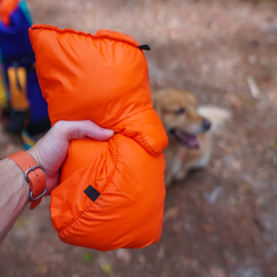Ultralight Dog Quilt rolled up small in one hand