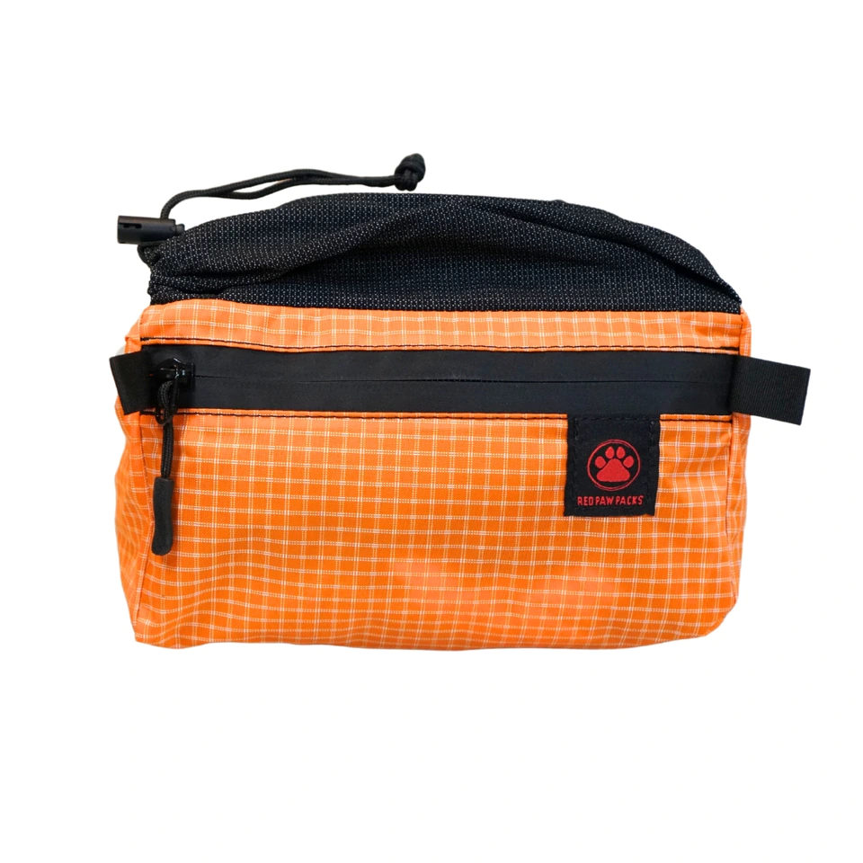 Flex Fanny Pack in orange grid fabric with a black stretch mesh top pocket
